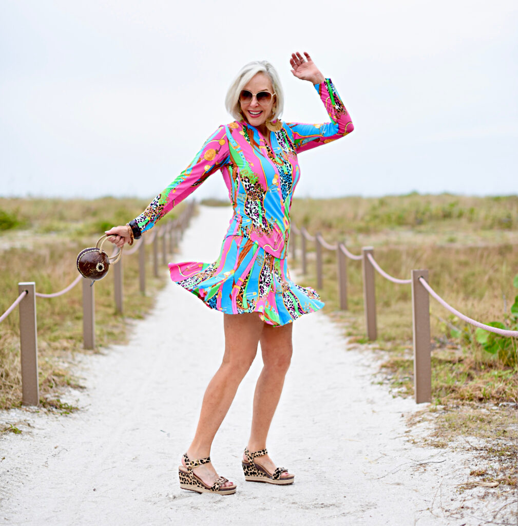 Sheree Frede of the SheSheShow multi-colored spf longsleeve top and skirt, big straw hat, coconut bag, leopard print sandals