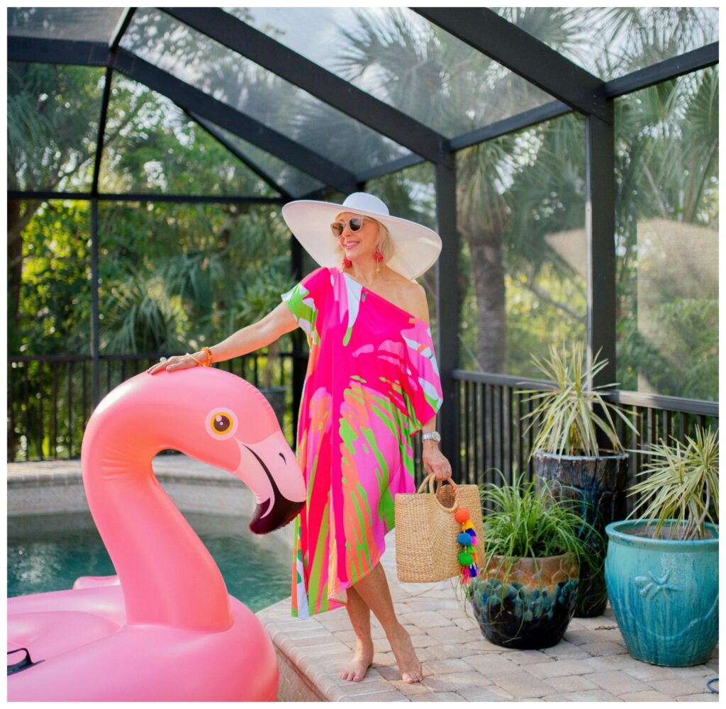 Sheree frede standing by Flo the flamingo pool float