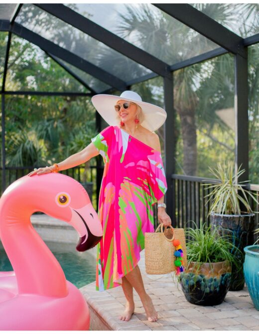 Sheree frede standing by Flo the flamingo pool float