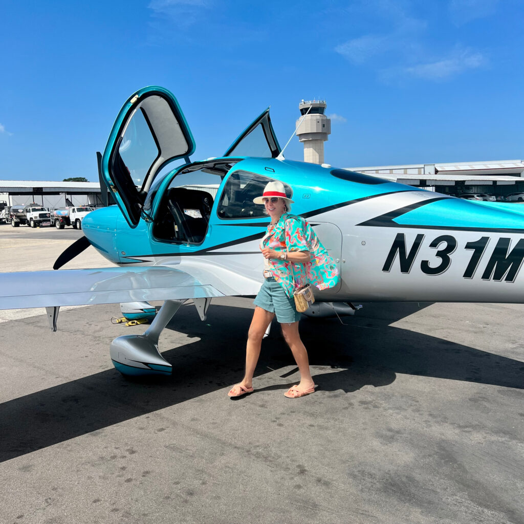 SheShe by airplane wearing denim shorts