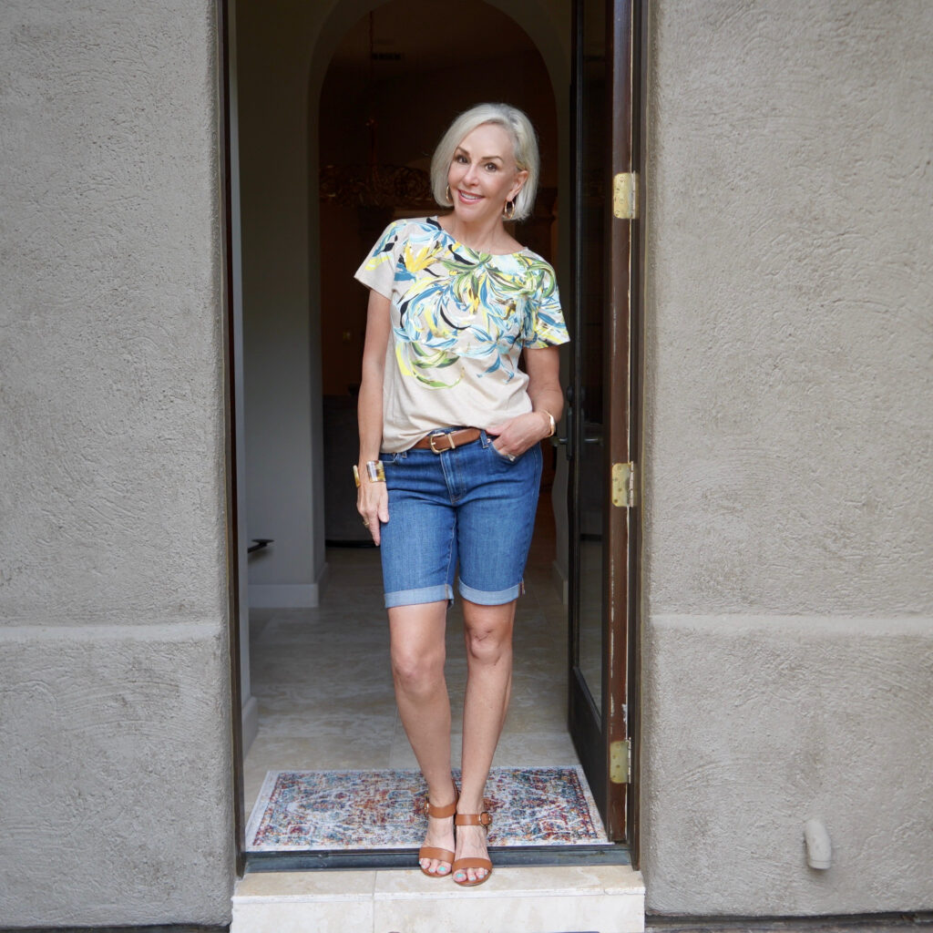 Sheree Frede of the SheShe Show standing in foor wearing a tee shirt and denim shorts