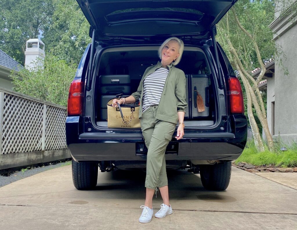 Sheree Frede of the SheShe Show standing behind a Tahoe with bags