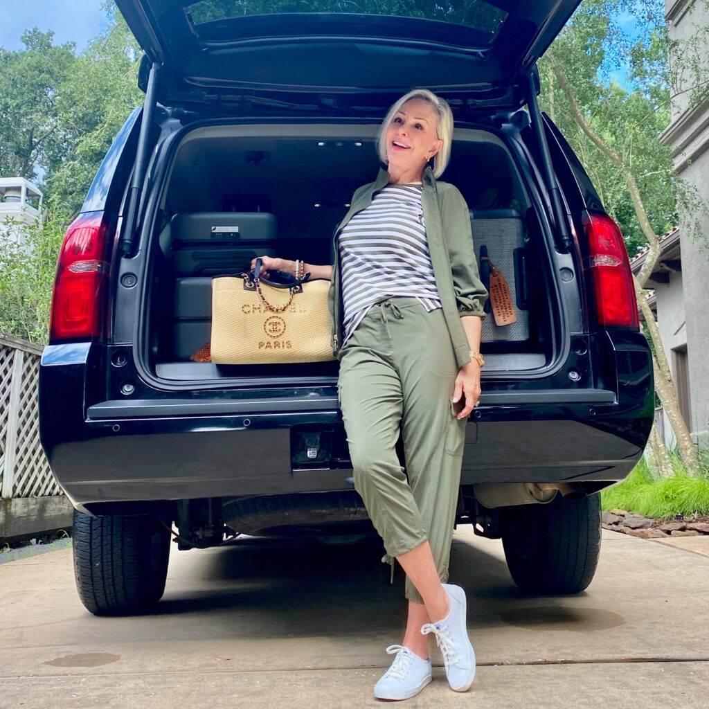 Sheree Frede of the SheShe Show standing behind a Tahoe with bags 