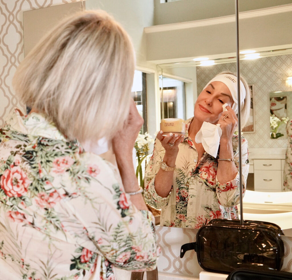 Sheree Frede of the SheShe Show in the bathroom cleaning her face with Colleen Rothschild products