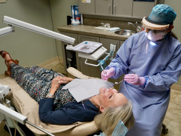 Sheree Frede of the SheShe Show in dental chair getting her teeth cleaned