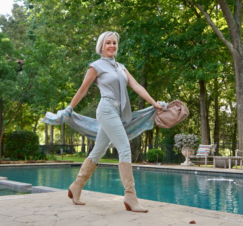 Sheree Frede of the SheShe Show wearing an icy blue jeans and silky top with suede western boots