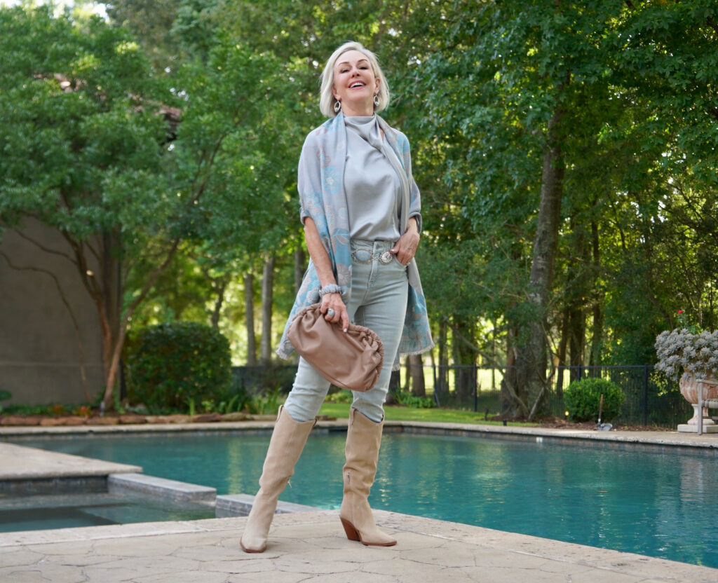 Sheree Frede of the SheShe Show wearing an icy blue jeans and silky top with suede western boots