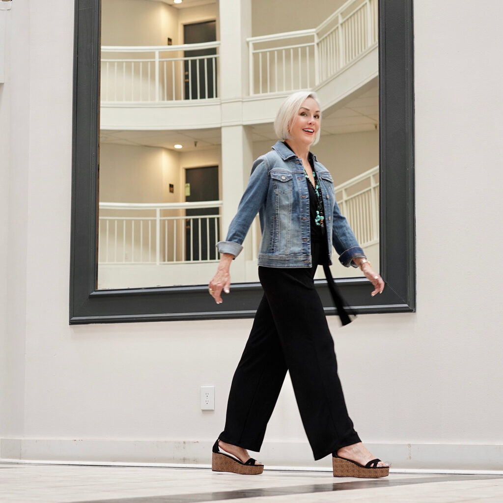 Sheree Frede of the SheShe Show wearing a Chico's black jumpsuit and denim jacket