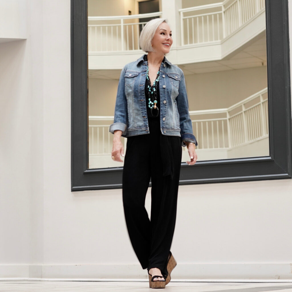 Sheree Frede of the SheShe Show wearing a Chico's black jumpsuit and denim jacket