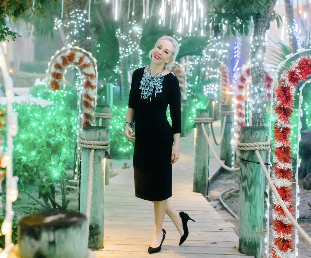 Sheree Frede of the SheShe Show wearing a Chico's black dress with bold crystal necklace