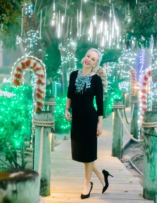 Sheree Frede of the SheSheShow walking down Candy Cane Lane on Captiva Island, Fla wearing a black dress and large crystal necklace fior her New Years Look