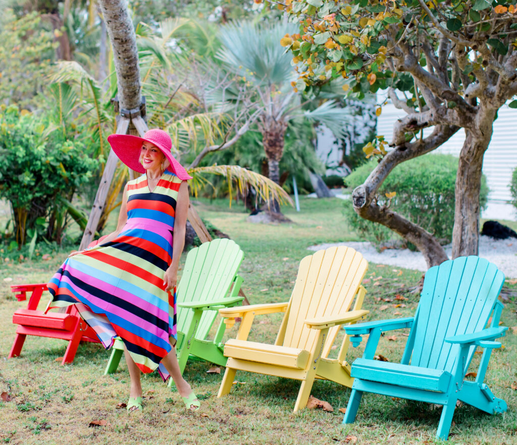 Sheree Frede of the SheShe Show wearing a Coldesina stripe midi dress with big pink hat