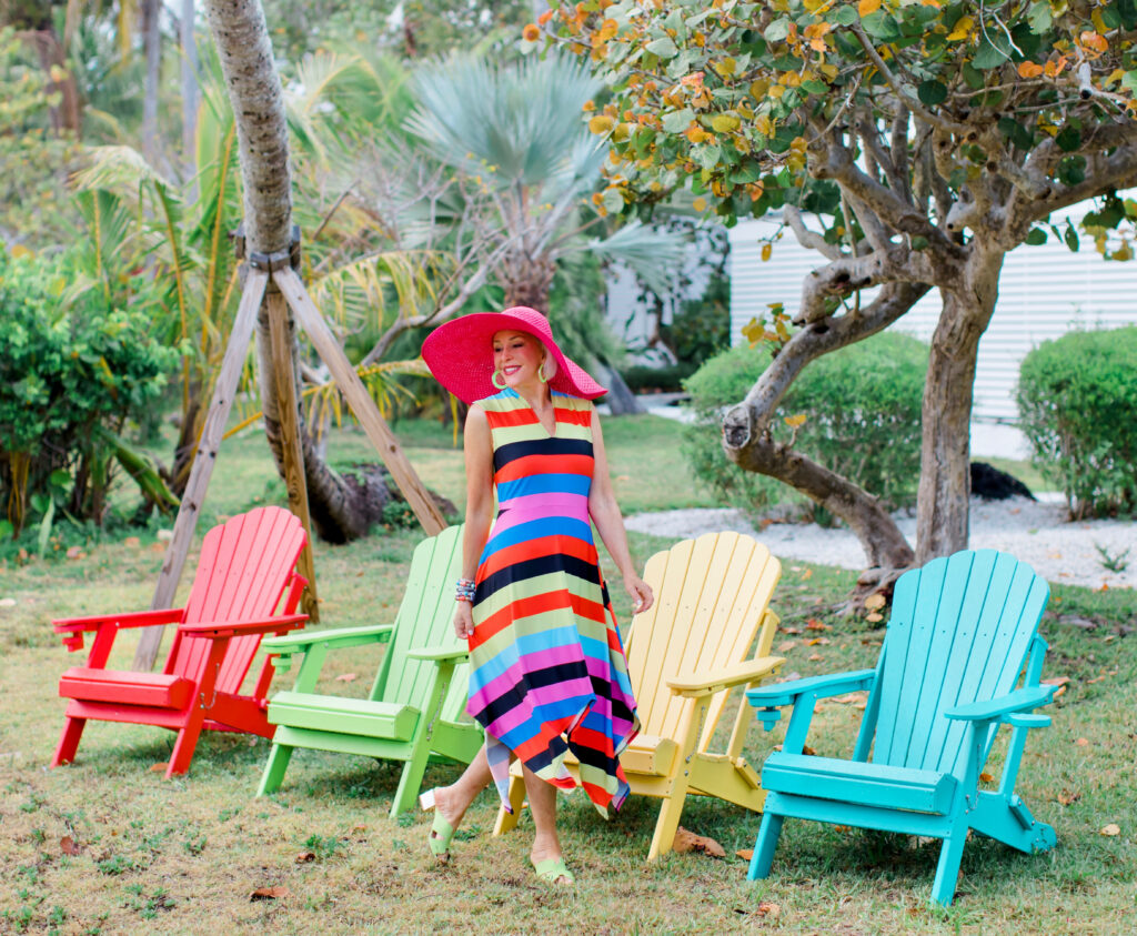 Sheree Frede of the SheShe Show wearing a Coldesina stripe midi dress with big pink hat