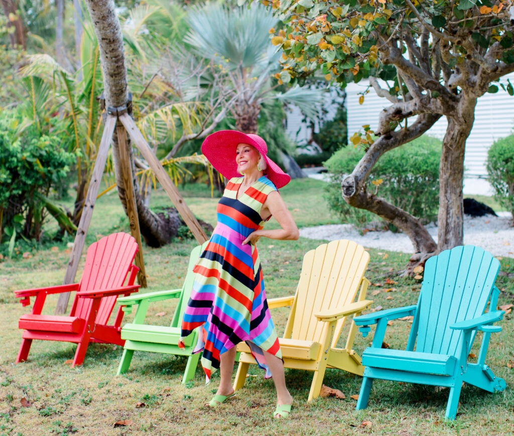 Sheree Frede of the SheShe Show wearing a Coldesina stripe midi dress with big pink hat