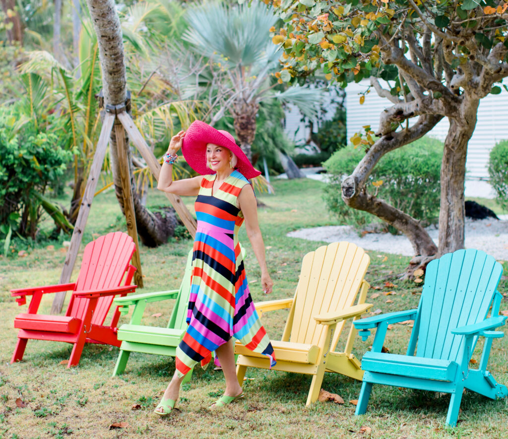 Sheree Frede of the SheShe Show wearing a Coldesina stripe midi dress with big pink hat