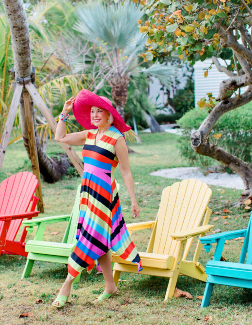 Sheree Frede of the SheShe Show wearing a Coldesina stripe midi dress with big pink hat