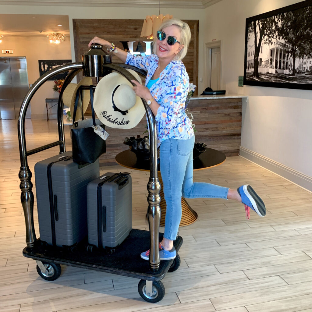 Sheree on luggage cart with luggage 