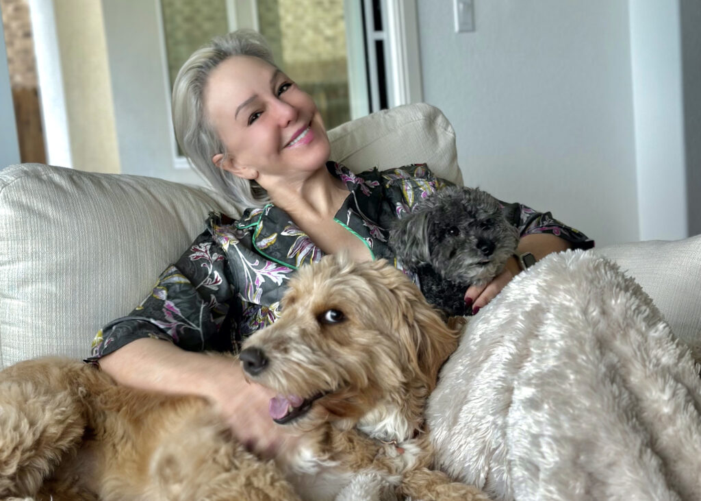 Sheree cozy with dogs on couch