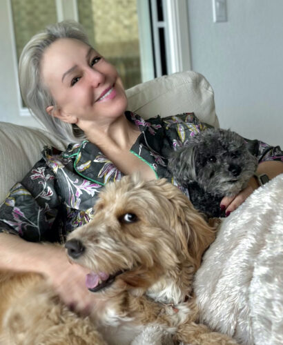 Sheree cozy with dogs on couch