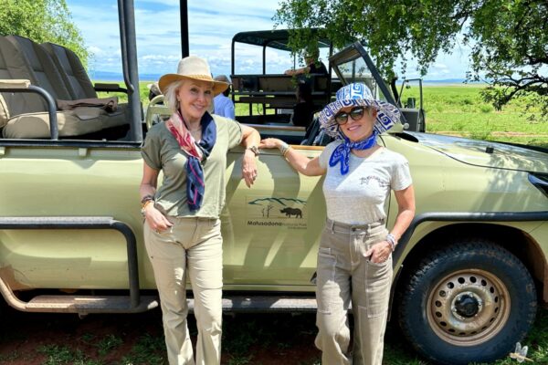 Shauan and Sheree standing in front of safari vehicle