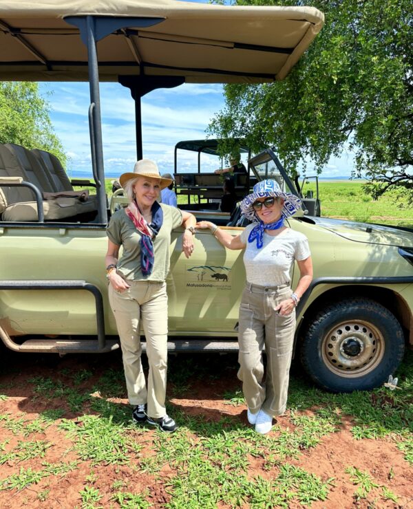 Shauan and Sheree standing in front of safari vehicle