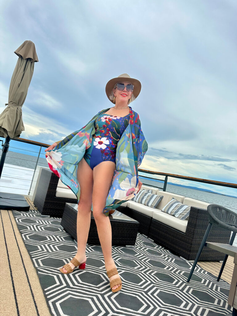 Sheree Frede on rooftop of the African Dream ship posing in her floral one piece swimsuit