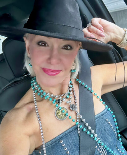 Sheree Frede wearing layered necklaces, hat and denim bustier