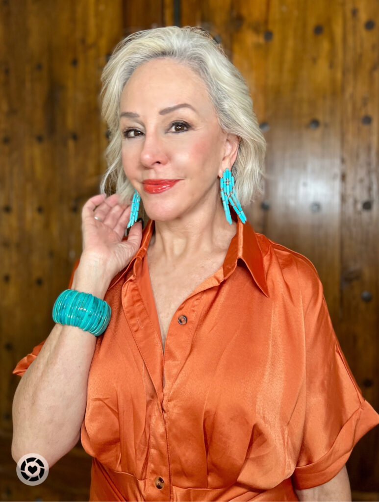 Sheree Frede wearing Kendra Scott turquoise earrings and orange silk dress