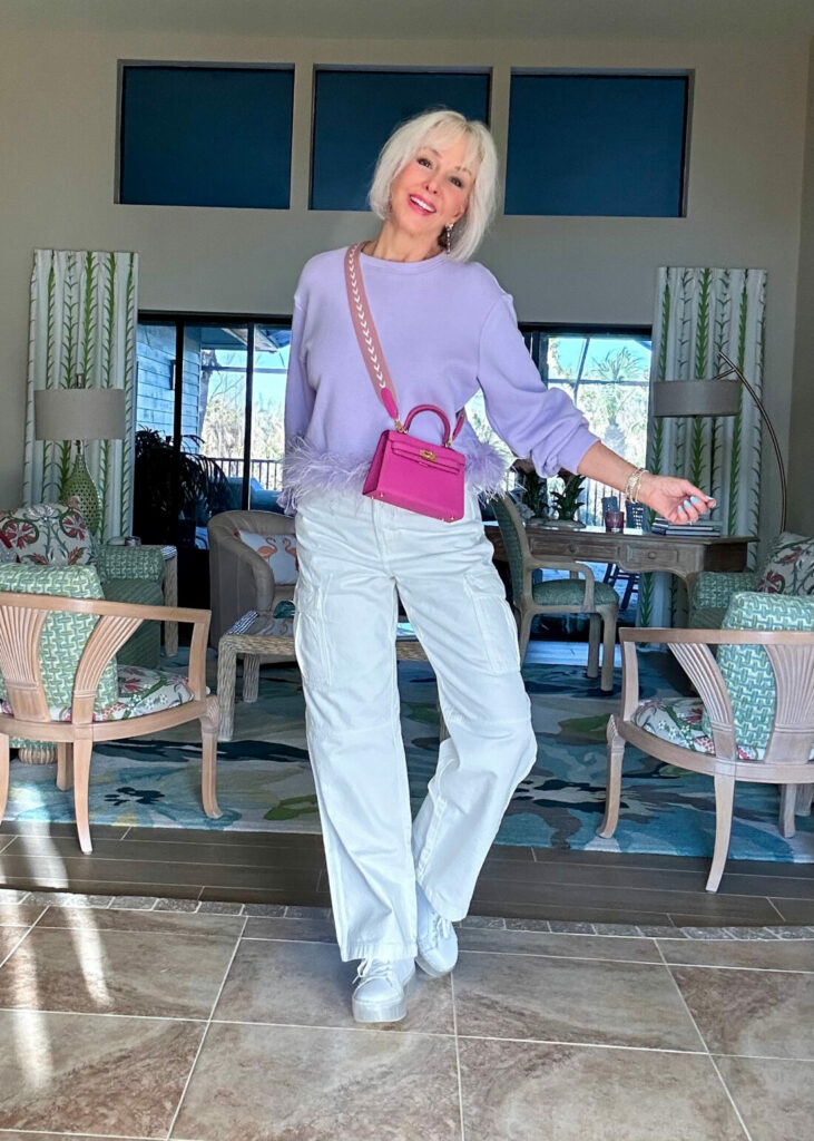 Sheree Frede wearing white wide leg pants and lavender sweatshirt