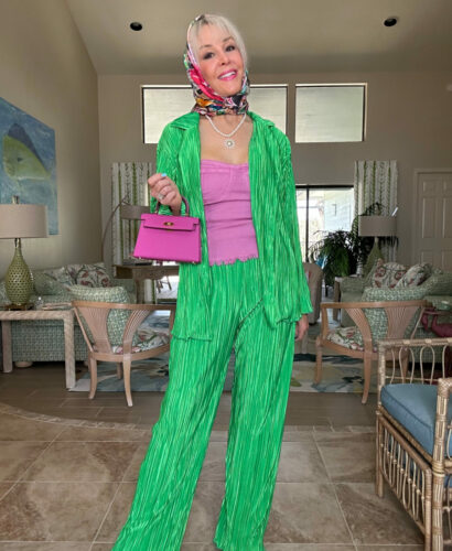 Sheree Frede wearing a green pants set with small woven handbag