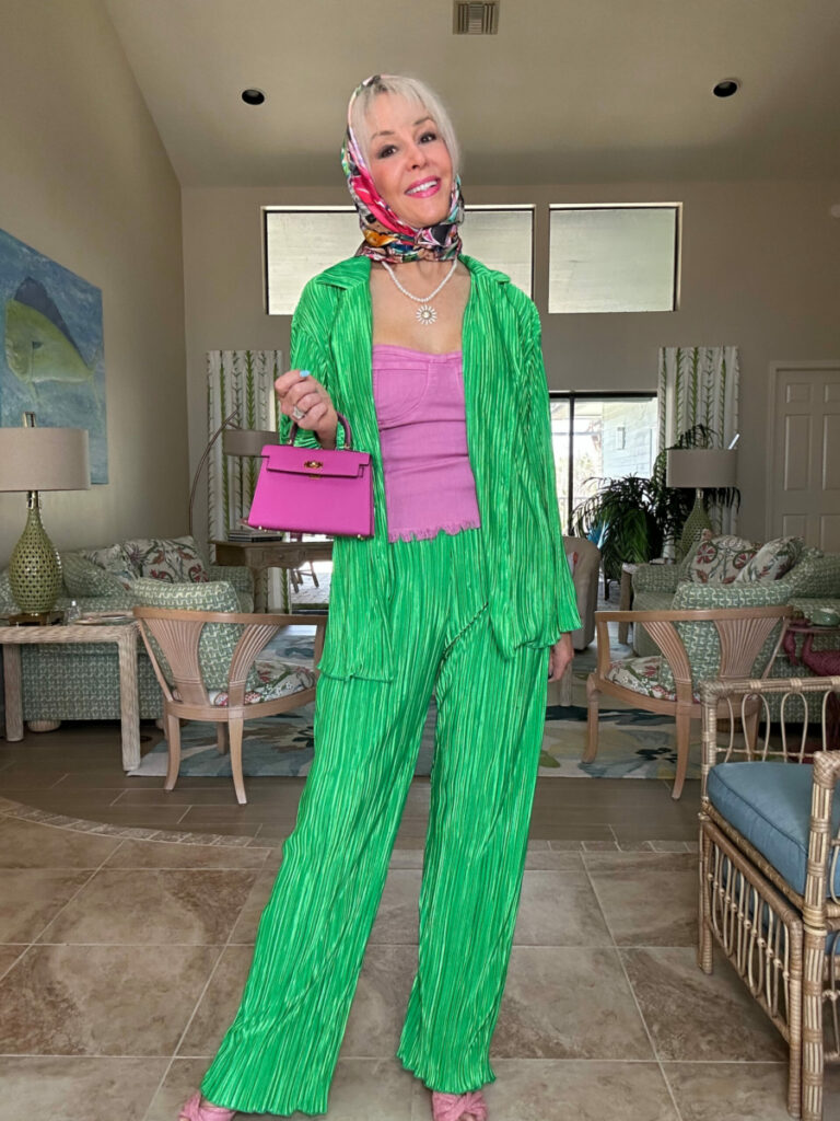 Sheree Frede wearing a green pants set with small woven handbag