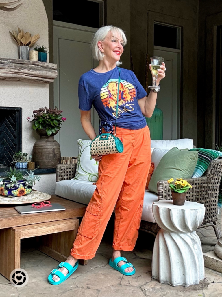 Sheree Frede wearing orage pants and T shirt with small woven handbag