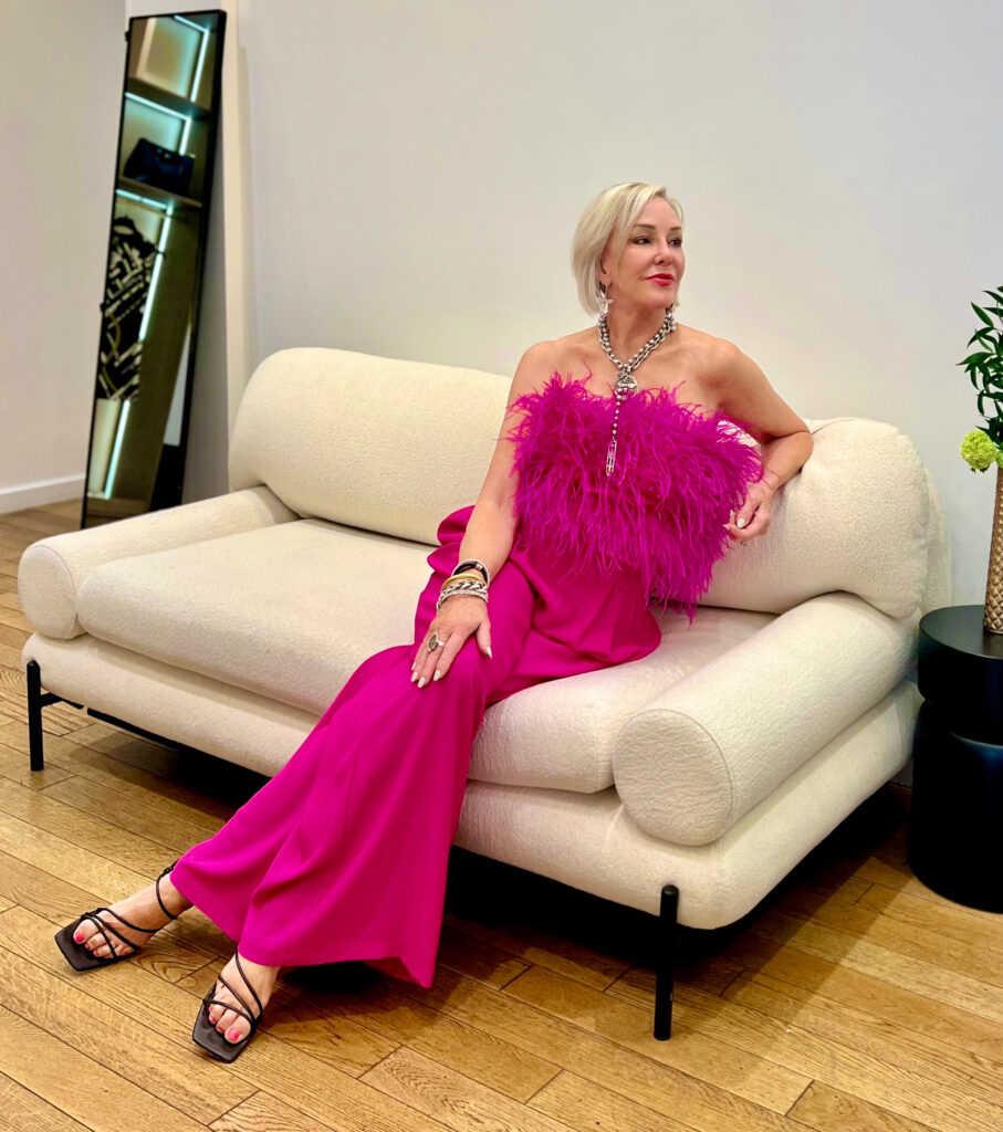 Sheree of the SheShe Show wearing a hot pink feather bustier and palazzo pants