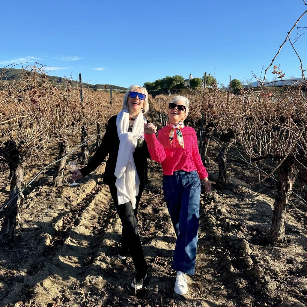 Sheree and Shauna strolling through a wine vinyard