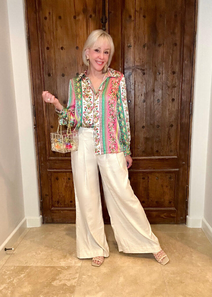 Sheree Frede Wearing a pink and green print long sleeve satin shirt over off white baggy long pants
