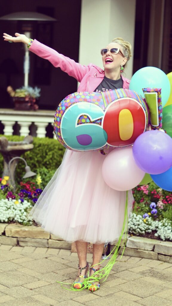 Sheree Frede wearing a pink tulle skirt holding birthday balloons