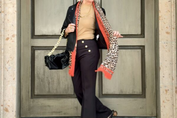 Neutral top paired with black pants with trending leopard scarf