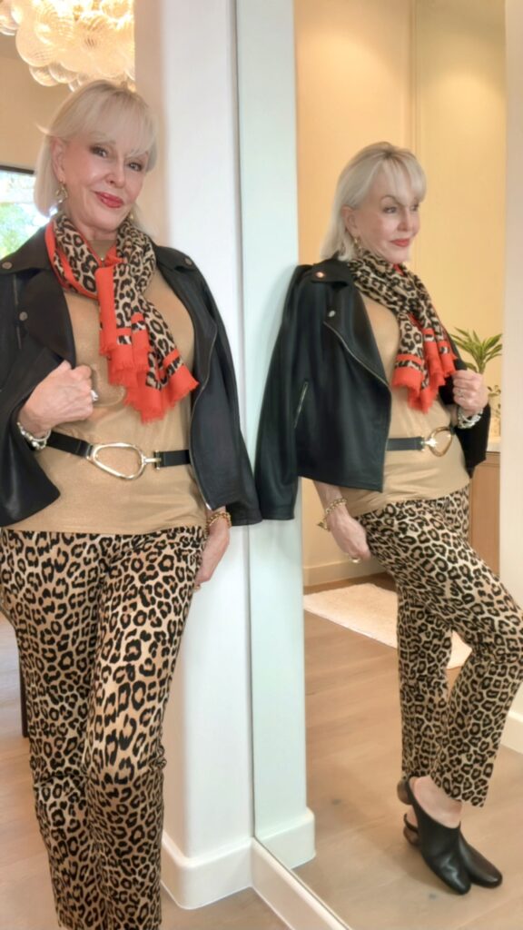 leopard pants paired with neutral top and accessorized with leather jacket and leopard scarf