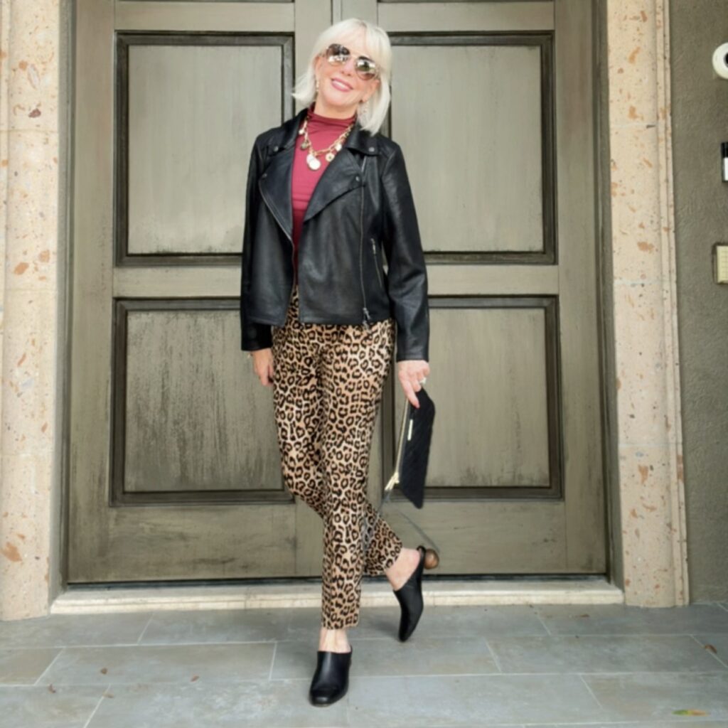 Leopard pants paired with red blouse and leather jacket